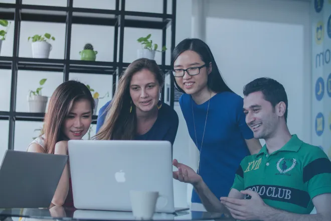 People looking at a laptop